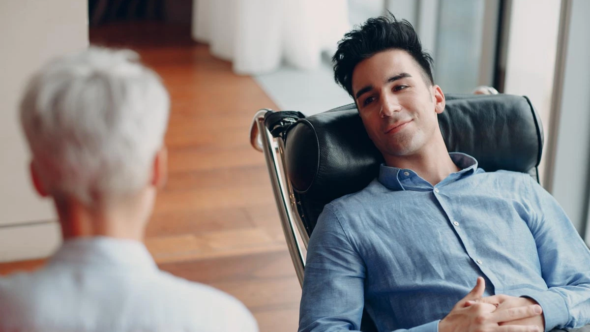 White text on blue background explains the cyclical nature of Bipolar Disorder. Image of man leaning back on a chair.