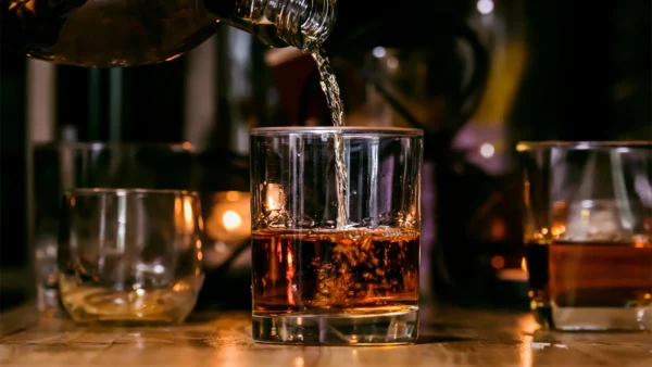 alcohol being poured into a cup