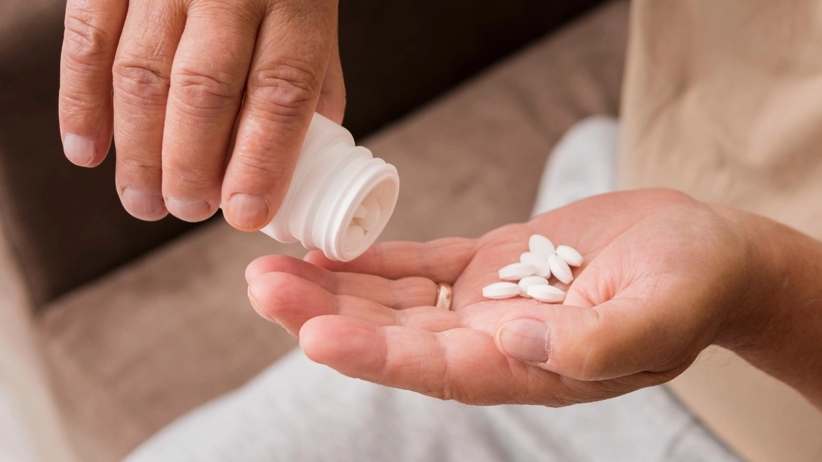 pouring pills into a hand