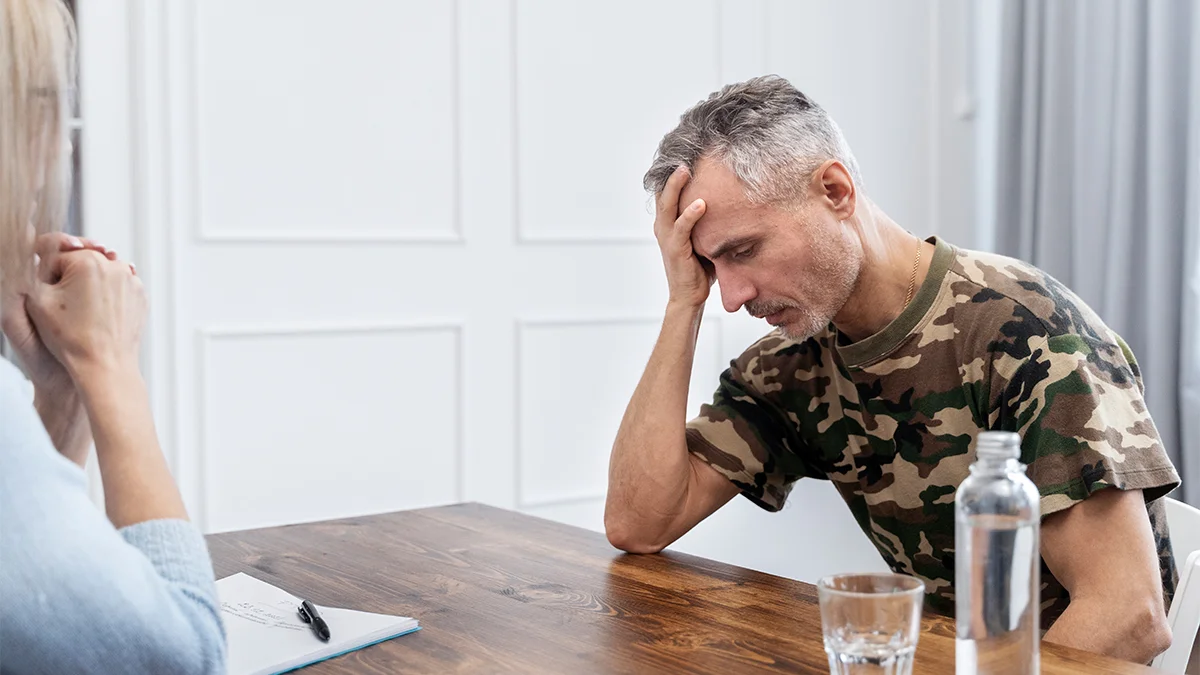 distressed man with his hand on his forehead