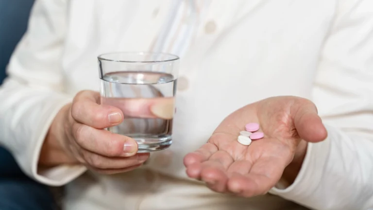 man with water in one hand and tranxene in the other